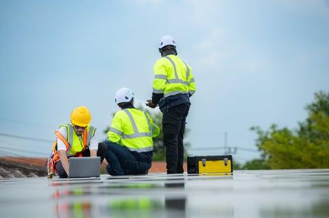 Maintenance crew on commercial roof