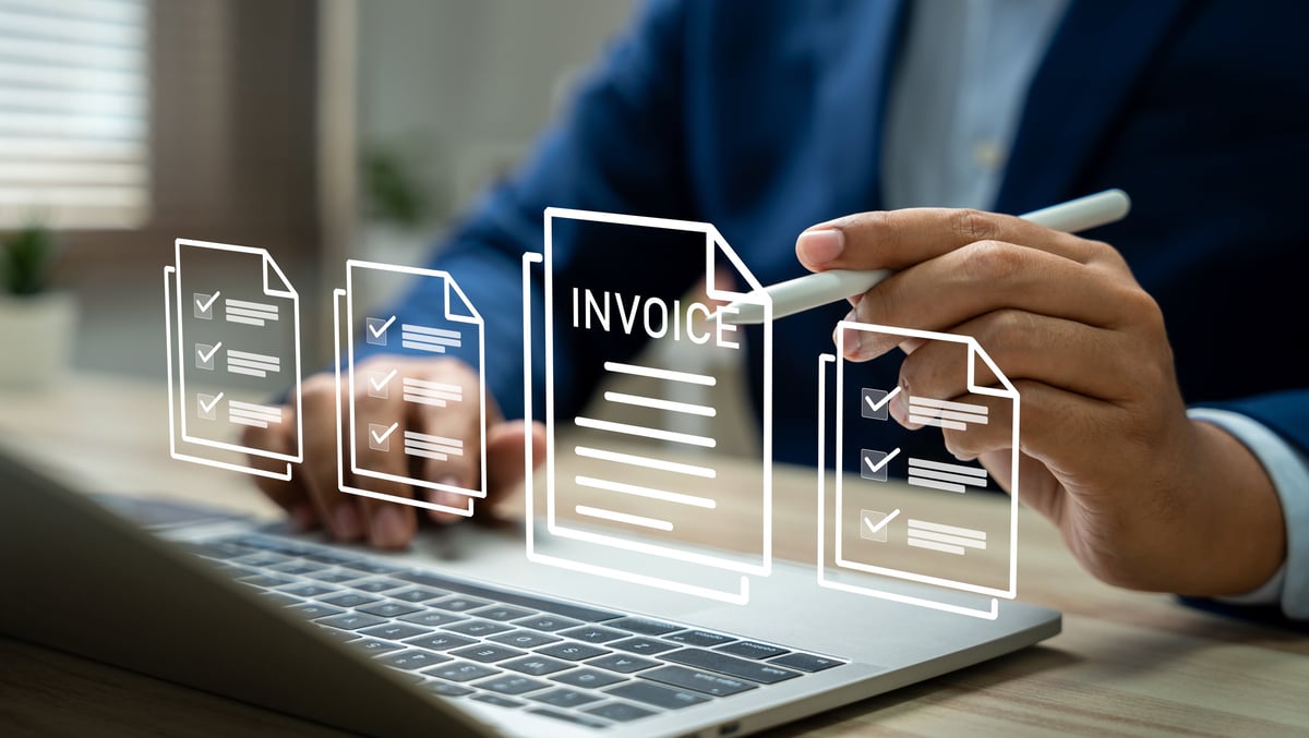 Businessman using laptop to manage electronic invoices and digital billing