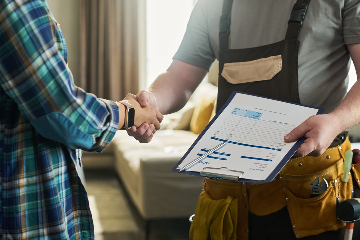 Contractor shaking hands with client confirming service completion