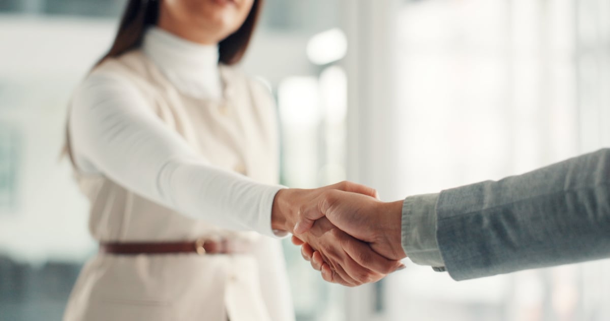 Shaking hands representing deal success and onboarding at a company