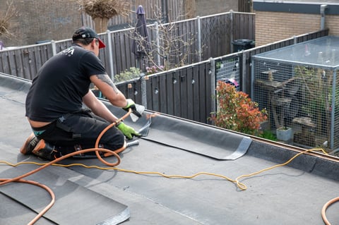 Professional roofer working on flat roof