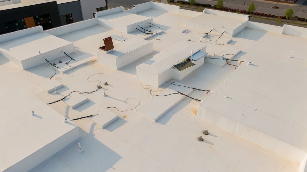 A high-resolution technical drone inspection photo of a commercial TPO roofing system